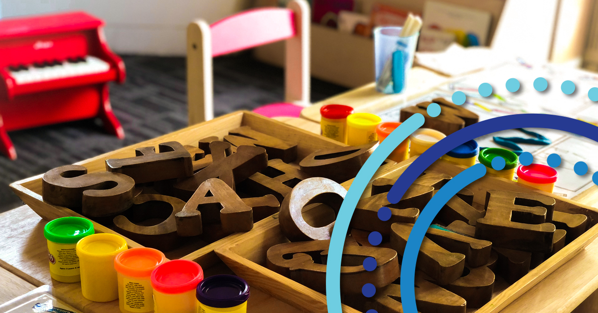 School setting with table chairs and letters