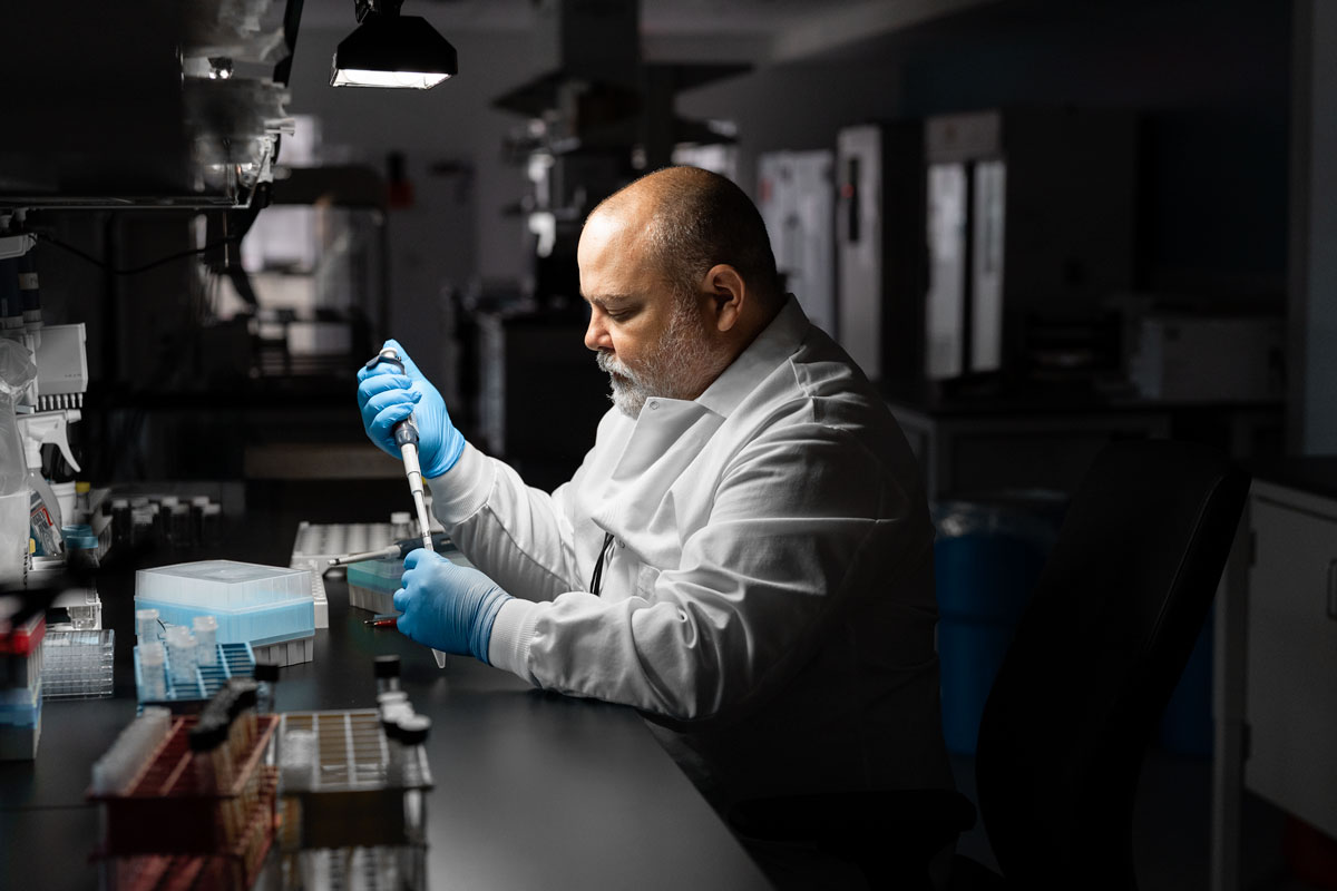 Tuberculosis Research Laboratory Testing for Antimicrobial Drug Development Scientist in a laboratory performing microbiology testing using a pipette and sample tubes